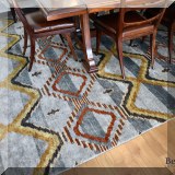 DR02. Multi-colored red rug. Measures approx. 13'5” x 12' 